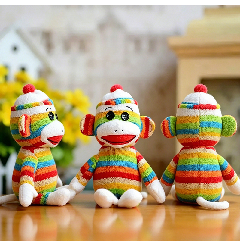 Custom rainbow striped sock monkey plush toys based on customer designs